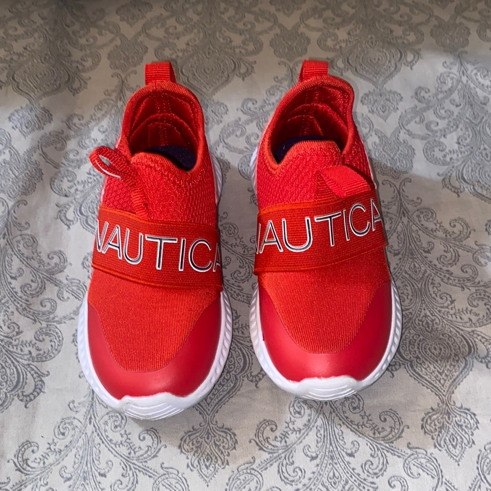 Red and white Nautica toddler sneakers.